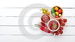 Preparation of tomato sauces and seasonings. Cherry tomatoes, spices, chili peppers. Top view.