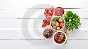 Preparation of tomato sauces and seasonings. Cherry tomatoes, spices, chili peppers. Top view.