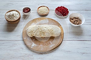 Preparation of traditional Arabic pizza manaqish with meat.