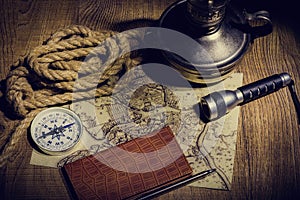 Preparation for travel on an old map with a compass a dark background