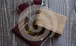 Preparation for travel, sunglasses, wallet, passport on wood floor vintage style