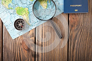 Preparation for Traveling concept, passport, compass, map on a wooden background.