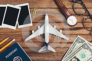 Preparation for Traveling concept, pencil, money, passport, airplane, watch, eyeglasses, photo frame.