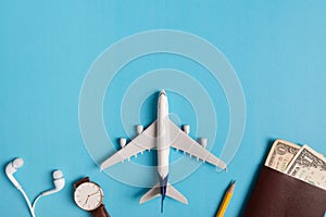 Preparation for Traveling concept, watch, airplane, money, passport, pencils, book.