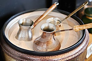 Preparation of Turkish coffee in cezve in sand