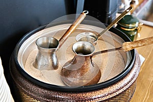 Preparation of Turkish coffee in cezve in sand