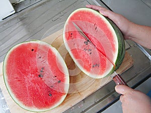 Preparation of watermelon slice by knife.