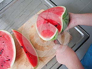 Preparation of watermelon slice by knife.