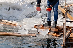 Preparation of winter ice-hole for swimming