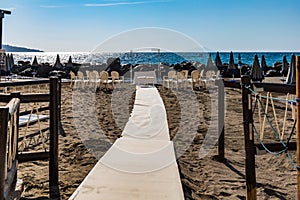 Preparations of wedding party on small beach next to sea