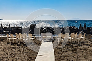 Preparations of wedding party on small beach next to sea