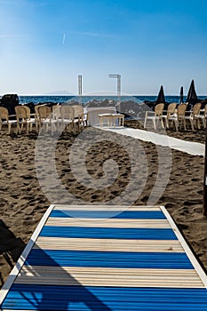 Preparations of wedding party on small beach next to sea