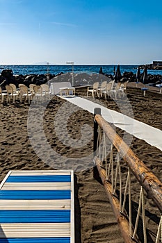 Preparations of wedding party on small beach next to sea