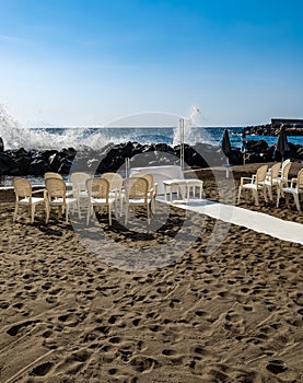 Preparations of wedding party on small beach next to sea