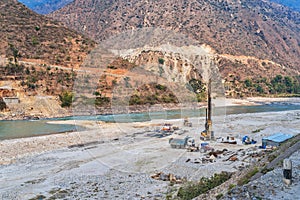 Preparatory work is underway to make pillars of the future bridge over a mountain river