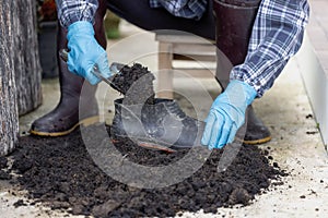 Prepare black soil in used plastic containers. for planting Conserving natural resources and the environment sustainable world