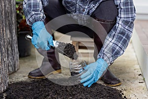 Prepare black soil in used plastic containers. for planting Conserving natural resources and the environment sustainable world