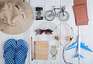 Prepare for journey - accessories and travel items, packing clothes: hat, passport, tickets, model of airplane and bicycle, flip