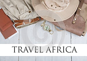 Prepare for journey in africa style - accessories and travel items, packing clothes in backpack: backpack, passport, tickets, hat