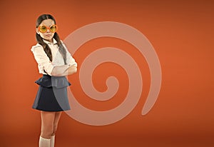 Prepare kid first school day. Schoolgirl cute ponytails. Excellent pupil concept. Girl wear school uniform orange