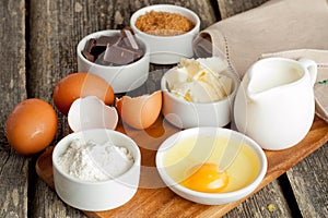 Prepared baking ingredients on wooden table, horizontal