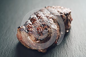 Prepared beef steack on slate board closeup