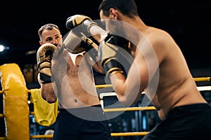 Prepared boxer blocking a hit to the head