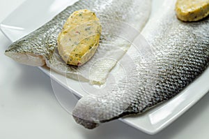 Prepared for fry boneless sea bass fillets with a lemon and pepper butter