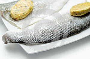 Prepared for fry boneless sea bass fillets with a lemon and pepper butter