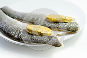 Prepared for fry boneless sea bass fillets with a lemon and pepper butter