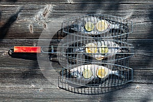 Prepared for grilling dorada fish on wood table