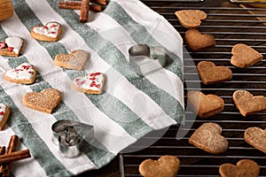 Prepared homemade heart-shaped cookies with icing on cloth napkin