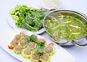 Prepared hot pot of fish ball with bitter melon on white platter