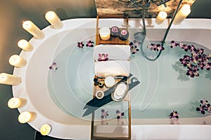 Spa bath with flowers, candles and tray