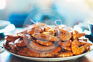 prepared orange shrimp on background table on kitchen, closeup of fresh prawn products in restaurant, shellfish sea food