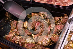 Prepared pork collar for barbecue on display