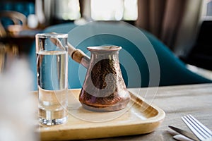 Prepared set of traditional turkish coffee drinking ceremony for breakfast including cup, water and pot