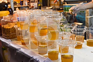Prepared vietnamese ice tea Tra Tac with kumquat, black tea,sugar cane, without ice in street food