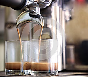 prepares espresso in his coffee shop; close-up