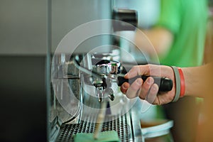 Prepares espresso in his coffee shop, close-up