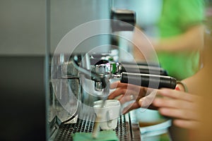 Prepares espresso in his coffee shop, close-up