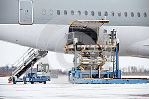 Preparing the aircraft before flight. Loading of baggage. Loading of cargo. Loading platform of air freight to the