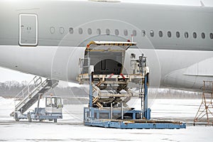 Preparing the aircraft before flight. Loading of baggage. Loading of cargo. Loading platform of air freight to the