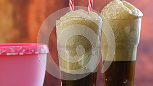 Preparing black cow cola ice cream soda floats