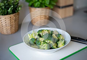 Preparing broccoli cut in white bolw