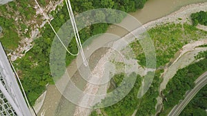 Preparing of bungee cord for jumping in mountains from bridge