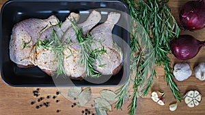 Preparing chicken drumsticks for roasting or stewing. Puts chicken legs in baking dish. Cooking baked chicken