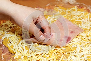 Preparing chicken specialties with cheese and ham