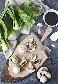 Preparing for chinese meal. Cooking Ingredients: bok choy, mushrooms, garlic and soy sauce in bowl.