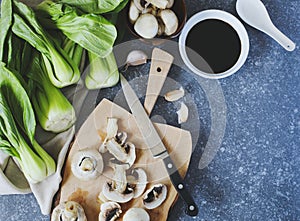 Preparing for chinese meal. Cooking Ingredients: bok choy, mushrooms, garlic and soy sauce in bowl.